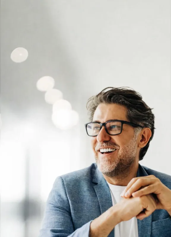 Smiling and confident business leader in a bright professional office.